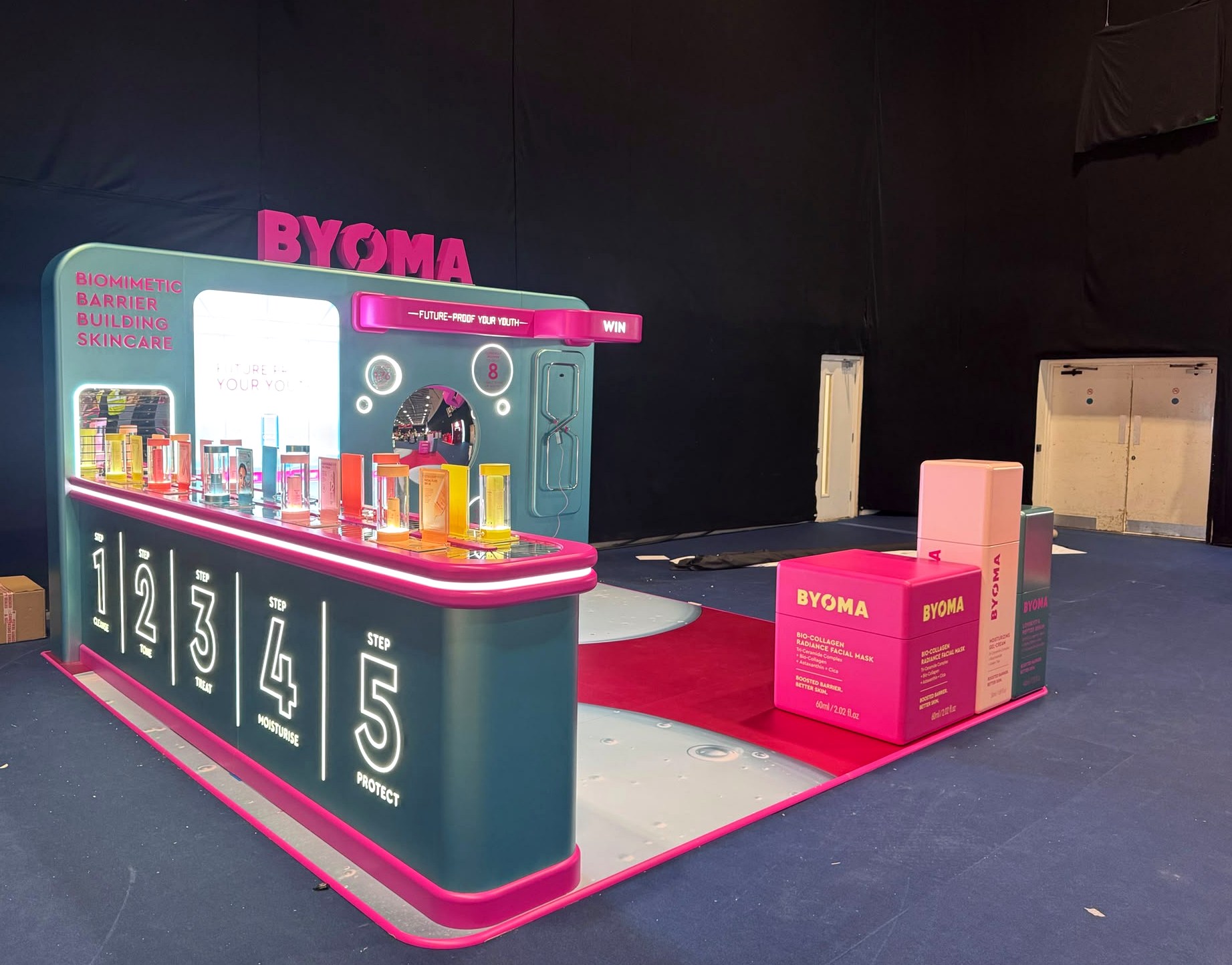 Side view of BYOMA event activation with glowing display graphics