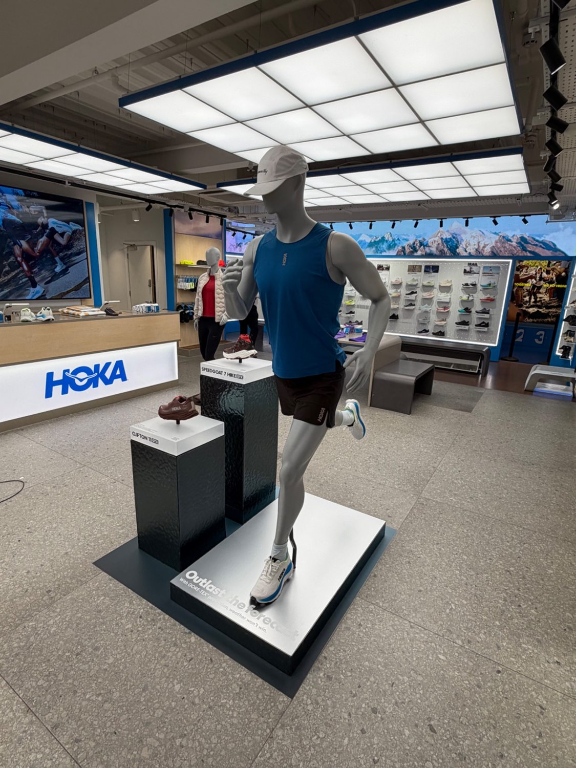 HOKA running mannequin and footwear display in store