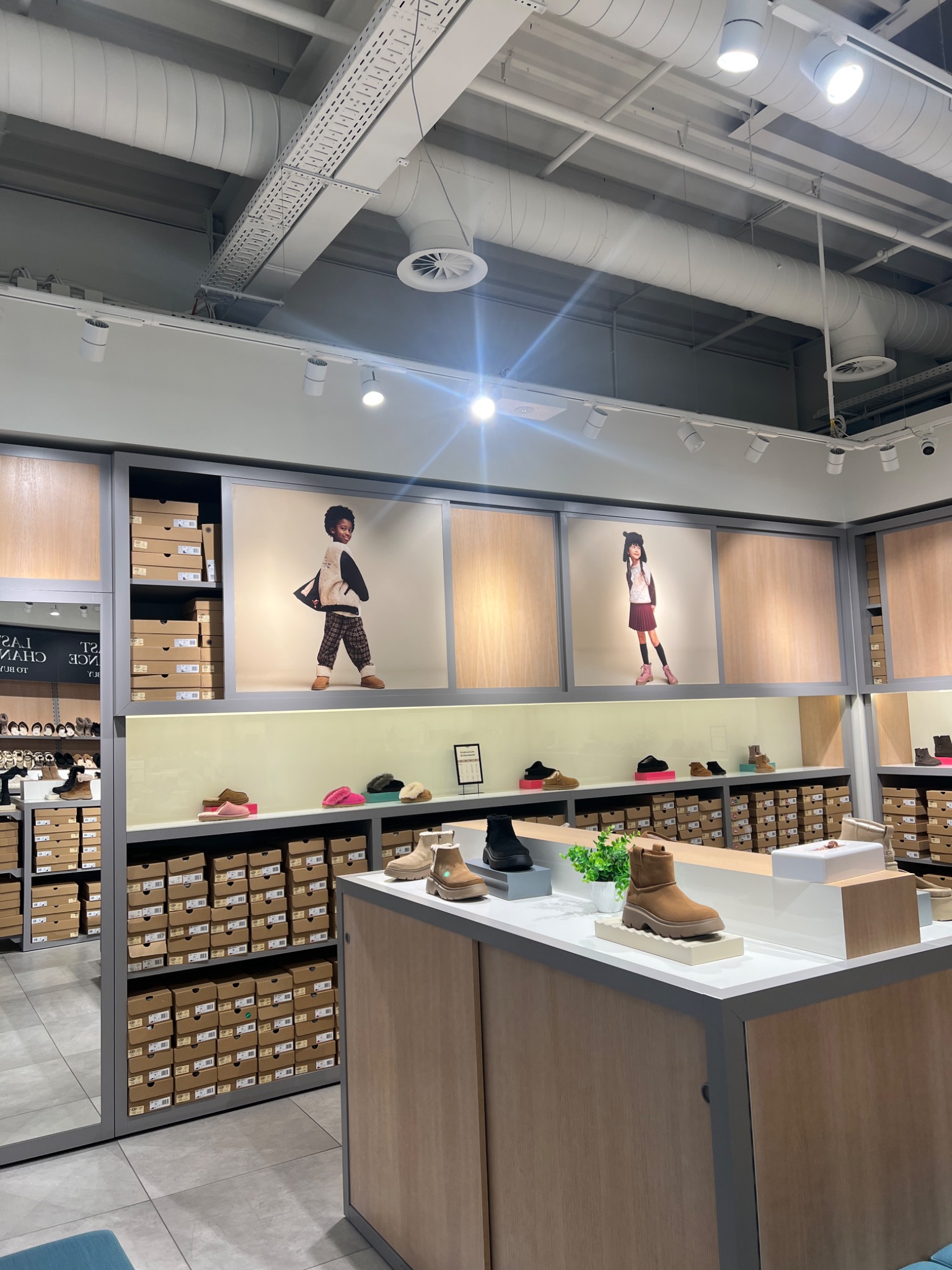 UGG retail installation with campaign imagery and footwear displays
